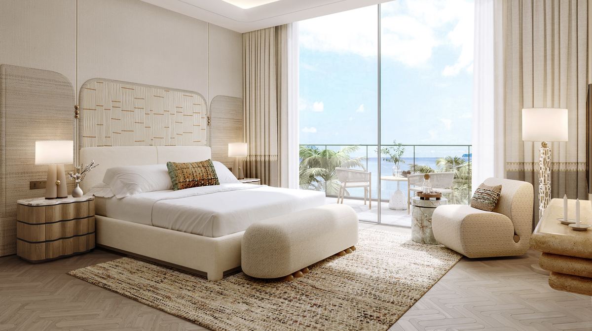 Principal suite opening onto a balcony with palm and sea views at Nasim Al Bahr Residences